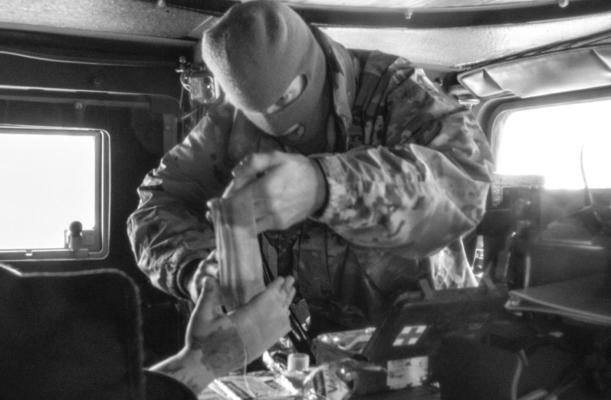 Spc. Parker Sargent, provides first aid to a motorists on the Turner Turnpike following a wreck near Chandler, Oklahoma.