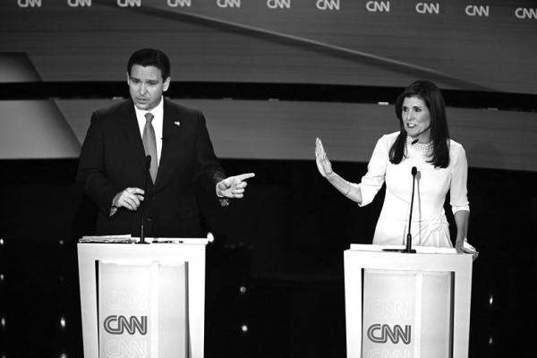 FLORIDA GOV. Ron DeSantis, left, and former U.S. Ambassador to the UN Nikki Haley speak during the fifth Republican presidential primary debate, at Drake University on Wednesday, Jan. 10, 2024, in Des Moines, Iowa. (Jim Watson/AFP/Getty Images/TNS)