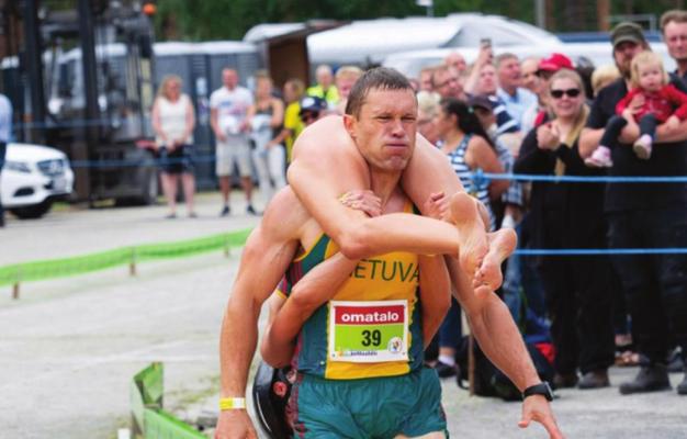 THIS MAN heads for the finish line in a wife carrying contest in Europe.