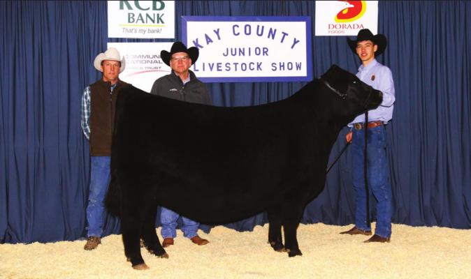 Supreme Heifer, Kent Tripp(right) with show judge Jeff Bedwell (middle) and dad Joseph Tripp (left).