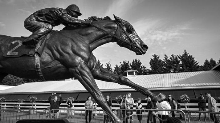 A STATUE of Triple Crown winner Secretariat by artist Jocelyn Russell catches the attention of visitors on a tour of Pimlico on Tuesday, May 16, 2023. Fifty years after Secretariat won the Preakness, racing lovers say there’s never been another horse like him, and there probably never will be. (Jerry Jackson/The Baltimore Sun/TNS)