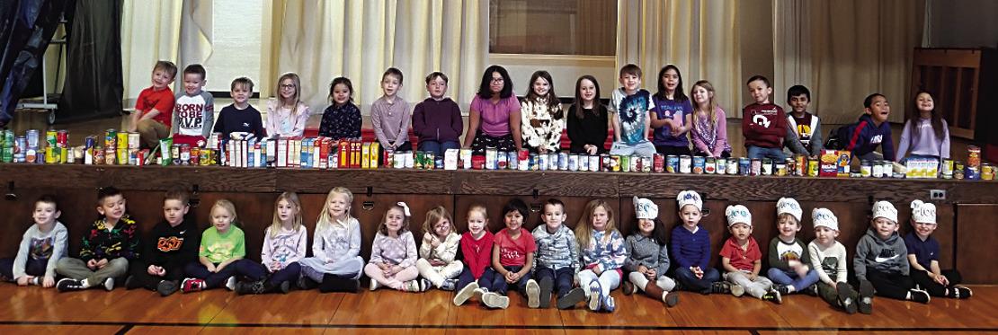First Lutheran School four-year-olds to first grade recently celebrated the 100th day of school by collecting over 100 cans of food for the food bank. Exceeding their goal, they collected 167 cans in total. Photo provided.