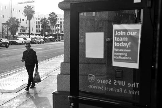 A person walks past a “Join our team today!” sign posted at a UPS store amid a still-robust labor market on Feb. 2, 2023, in Los Angeles, California. (Mario Tama/Getty Images/TNS)