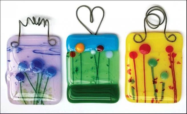 PARTICIPANTS IN “Glass and a Glass!” fundraiser for Heart in the Park will create an original fused glass suncatcher such as these “meadow flower” works made by Audrey Schmitz. The Feb. 20 lady’s night out event will also include drinks, appetizers and sweets provided by generous Tonkawa restaurants and businesses. Tickets are available at Tonkawa Chamber of Commerce, First National Bank and Frames &amp; Things.