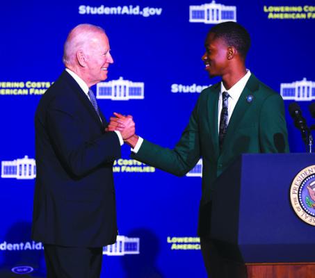 U.S. President Joe Biden is introduced by Zachary Bernard, a senior at Delaware State University, before giving remarks on student debt relief on Oct. 21, 2022, in Dover, Delaware. (Anna Moneymaker/Getty Images/TNS)