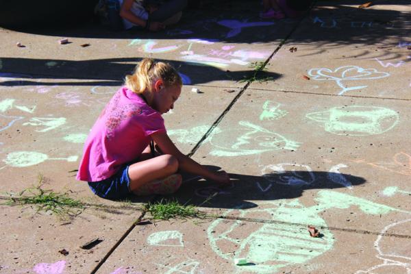 PONCA CITY children kick their Summer Arts Camp experience off with sidewalk chalk during the check-in and registration time. (Photo by Dailyn Emery)