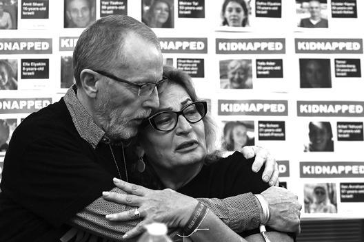 ORIT MEIR (right), mother of Almog Meir, hugs Thomas Hand, father of Emily Hand, during a press conference by families of hostages held by Palestinian militant group Hamas in Gaza, at the embassy of Israel in London on Nov. 20, 2023. (Henry Nicholls/ AFP via Getty Images/TNS)