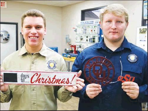 PIONEER TECHNOLOGY Center students Matthew Mayes, a Po-Hi senior and Austin Ross, an adult student from Ponca City, show some of the crafts that will be sold at the Holiday Market Nov. 21. The market place hours are from 9 a.m. to 2 p.m. All proceeds will benefit Career Tech Student Organizations (CTSO). The public can also come during lunch from 11 a.m. to 12:30 p.m. and enjoy PTC’s annual Thanksgiving Dinner.