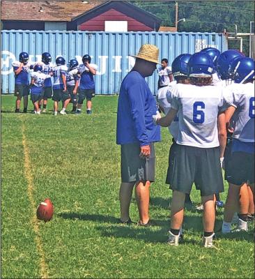 NEWKIRK COACH Eddy Scott talks to a huddle of Tiger players during a recent practice session. Scott is the new head coach at Newkirk.
