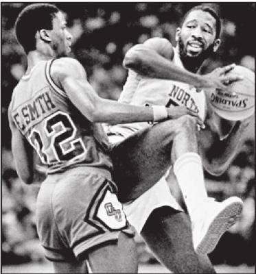 NORTH CAROLINA forward James Worthy, right, keeps the ball away from Eric Smith of Georgetown during the 1983 NCAA college basketball Final Four championship game in New Orleans. Worthy won the duel of dunks with Georgetown’s Pat Ewing, scoring a career-high 28 points and winning the Most Outstanding Player award. (AP Photo)