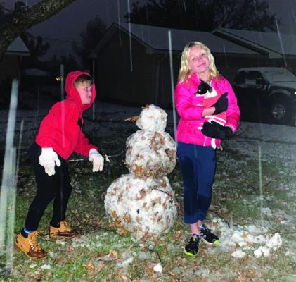 MAKING THE MOST OF IT — Residents Cooper and Khloe Sorrels made the most of Monday’s snow showers and built an impressive snowman (with just a few leaves and a bit of dirt) in their yard in Ponca City. Photo provided.