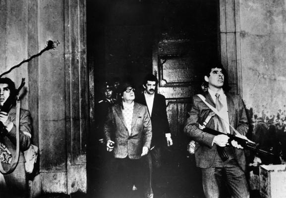 ARMED GUARDS watch out for attackers as Chilean president Salvador Allende leaves the Moneda Presidential Palace during the military coup in which he was overthrown and killed. (Luis Orlando Lagos Vázquez/Keystone/Getty Images/TNS)