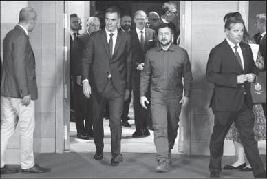 UKRAINE’S PRESIDENT Volodymyr Zelensky (right) walks with Spain’s Prime Minister Pedro Sanchez before the start of a plenary session of the European Political Community summit at the Palacio de Congreso in Granada, southern Spain on Oct. 5, 2023. Europe’s quest to build a common geopolitical purpose brought four dozen of its leaders to Granada, but its credibility suffered a blow when the Azerbaijani president stayed away. (Ludovic Marin/AFP via Getty Images/TNS)