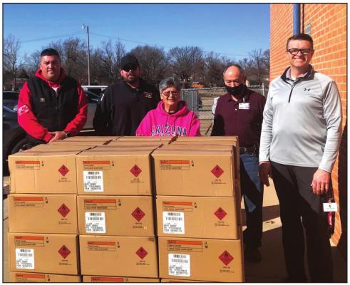 Kaw Nation donated a pallet of hand sanitizer to Woodlands Elementary. Pictured L to R are Skyler Matthews (Kaw Nation), Jim Warren (Kaw Nation), Pearl Canaday, Randy Logan, Tim Williams. (Photo Provided)