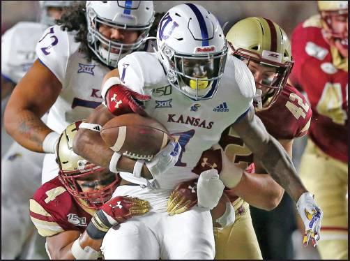 BOSTON COLLEGE wide receiver Zay Flowers (4) and linebacker Vinny DePalma (42) tackle Kansas running back Pooka Williams Jr. (1) during a college football game in Boston Friday. Kansas won 48-24. (AP Photo)