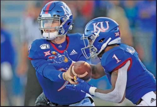 KANSAS QUARTERBACK Carter Stanley, left, hands off to running back Pooka Williams Jr. (1) during the first half of a football game against Texas Tech in Lawrence, Kan., Saturday. The Jayhawks will play Sunflower State rival Kansas State this week. (AP Photo)