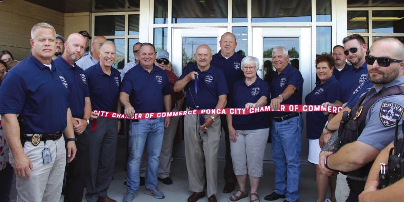A RIBBON cutting ceremony was held ahead of the open house for the new Public Safety Center. Cutting the ribbon is Mayor Homer Nicholson, he is joined by Chief of Police Don Bohon (behind the mayor), as well as various members of the commission, police department and city. (Photo by Calley Lamar)