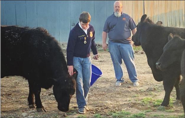 BOISE CITY Boise City FFA President Stran Wagner (left) and his father Justin look over the younger producer’s cattle before shipping them off to a family friend in Coyle who has available pasture resources currently lacking in the Oklahoma Panhandle. (Photo courtesy of the Cimarron County Extension Office)