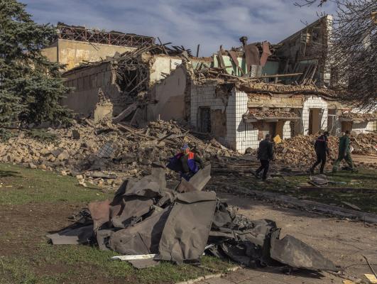 COMMUNAL WORKERS clear rubble following an overnight missile strike on a House of Culture in the town of Druzhkivka, Donetsk region, on April 1, 2024, amid the Russian invasion of Ukraine. (Roman Pilipey/AFP/Getty Images/TNS)