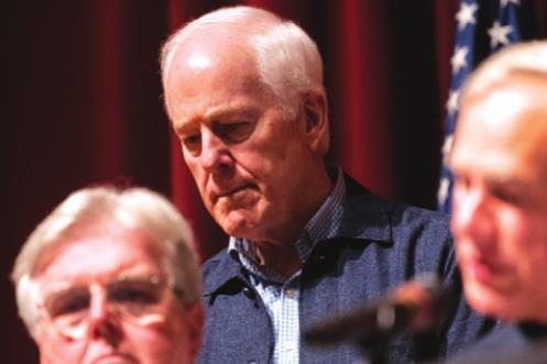 Sen. John Cornyn listens as Gov. Greg Abbott, flanked by Lt. Gov. Dan Patrick, briefs the press on May 25, 2022, at Uvalde High School about the massacre the previous day at nearby Robb Elementary School. (Juan Figueroa/The Dallas Morning News/TNS)