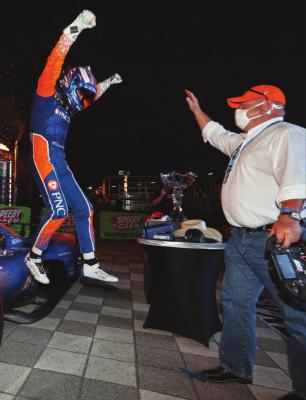 IN THIS PHOTO Iprovided by Chris Owens/INDYCAR Series, Scott Dixon, left, jumps off his car toward team owner Chip Ganassi as the two celebrate Dixon’s IndyCar auto race win at Texas Motor Speedway in Fort Worth, Texas, Saturday, June 6, 2020. (Chris Owens/INDYCAR Series via AP)