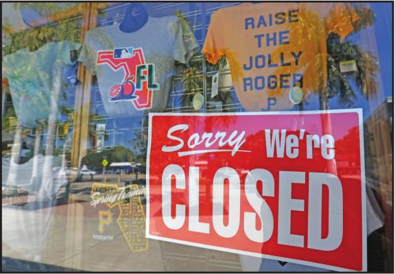 A CLOSED sign is displayed on the Pittsburgh Pirates spring training baseball gift shop at LECOM Park in Bradenton, Fla. Major League Baseball has delayed the start of its season by at least two weeks because of the coronavirus outbreak and suspended the rest of its spring training schedule. (AP Photo)