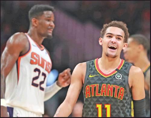 ATLANTA HAWKS guard Trae Young is all smiles during the final minutes of a 123-110 victory over Deandre Ayton and the Phoenix Suns in a Jan. 14 NBA game in Atlanta. Young, a former Oklahoma Sooner, has been elected as one of the NBA All-Star game’s starters. (AP Photo)