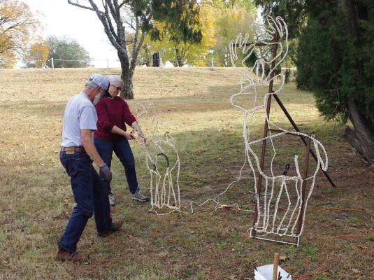 VOLUNTEERS HARD at work to set up the awe-inspiring light display at the historic Lake Ponca Park in preparation for the holiday season. (Photo by Dailyn Emery)