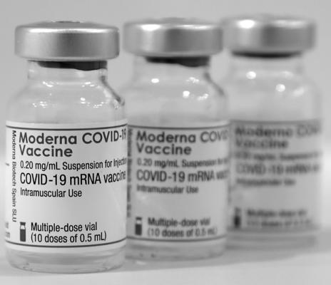 Three vials of the Moderna COVID-19 vaccine are pictured in Berlin in 2021. (Michael Sohn/Pool/Getty Images/TNS)