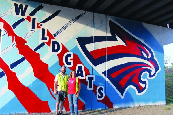 LOCAL ARTISTS Jeremy and Theresa Sacket are currently working on a project to paint murals on the railroad underpass located on Highland. Last year, the Sackets took to painting the murals on the Union Street bridge underpass that depicted several pieces of Ponca City iconography. (Photo by Calley Lamar)