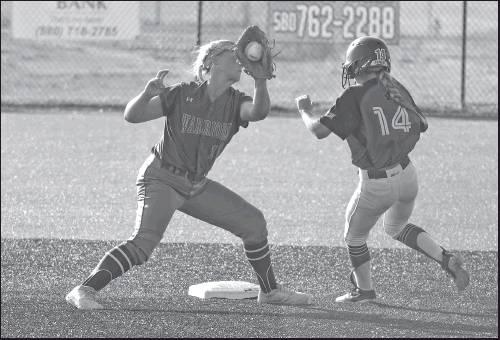 TARYN CONNELLY (14) of Ponca City tries to elude a tag at second base during a game Monday against Glenpool at the West Middle School softball field. Ponca City scored eight runs in the game, but lost 11-8. This photo was provided by Larry Williams.