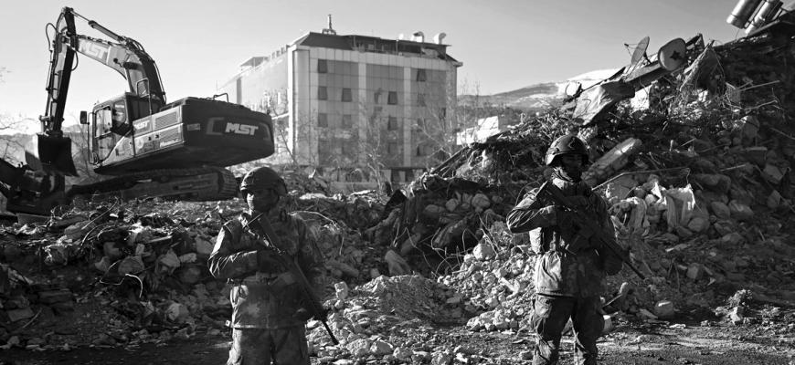 Turkish soldiers stand next to collapsed buildings in Kahramanmaras on Feb. 13, 2023, as rescue teams continue to search for victims and survivors, after a 7.8 magnitude earthquake struck the border region of Turkey and Syria. The death toll from a catastrophic earthquake that hit Turkey and Syria climbed above 35,000 on Feb. 13, 2023, with search and rescue teams starting to wind down their work. (Ozan Kose/AFP/Getty Images/TNS)