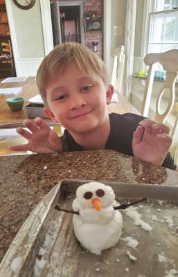 MIKAELA HARDESTY, 9, and Leo Hardesty, make baking soda snowmen during a distant learning science activity. They are the grandchildren of Allen and Vicki Hardesty.