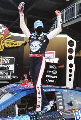 RACE DRIVER Kevin Harvick celebrates after winning the NASCAR Cup Series auto race at Indianapolis Motor Speedway in Indianapolis, Sunday, July 5, 2020. (AP Photo/Darron Cummings)