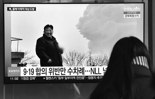 A woman watches a television screen showing a news broadcast with file footage of North Korean leader Kim Jong Un, at a railway station in Seoul on Dec. 31, 2022, after North Korea fired three short-range ballistic missiles according to South Korea’s military. (Jung Yeon-Je/AFP via Getty Images/TNS)