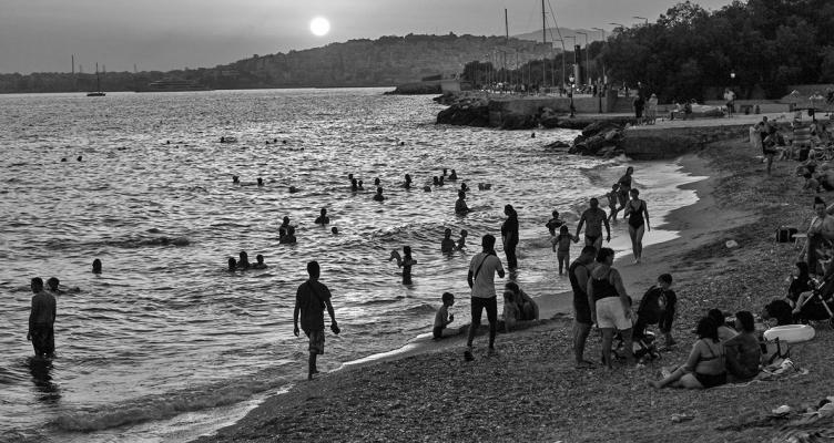 ATHENIANS ON Alimos city beac to cool them self after sunset during a heat wave on July 20, 2023, in Athens, Greece. The Acropolis of Athens and other archaeological sites in Greece announced reduced opening hours due to the heatwave conditions. Parts of Europe continue to experience extreme conditions of the Cerberus heatwave, dubbed Charon. (Milos Bicanski/Getty Images/TNS)