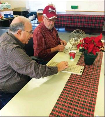 STAN LONG, left, and Jerry Hilbert, right, call the numbers for Bingo at the Wheeler Dealers Camping Club party.