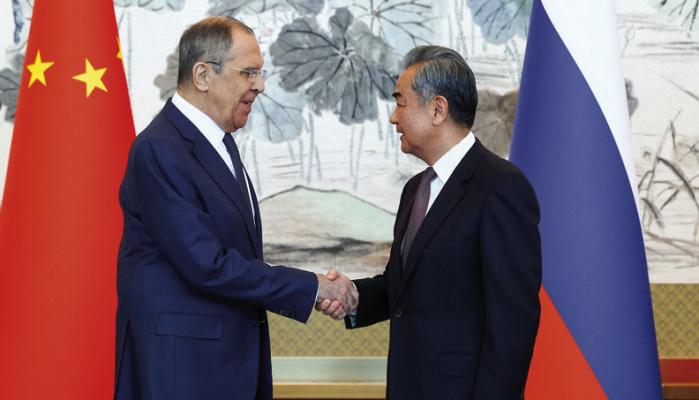 RUSSIA’S FOREIGN Minister Sergei Lavrov, left, and Director of the Chinese Communist Party Central Committee Foreign Affairs Commission Wang Yi shake hands during a press conference following a meeting in Beijing, China, April 9, 2024. (Russian Foreign Ministry Press Service/Tass/Abaca Press/TNS)