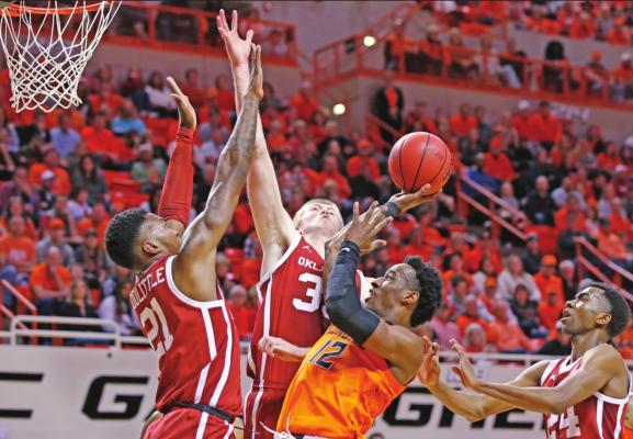 OKLAHOMA STATE forward Cameron McGriff (12) shoots between Oklahoma’s Kristian Doolittle (21), Brady Manek, rear, and Jamal Bieniemy (24) in a college basketball game in Stillwater Saturday. The Cowboys won 83-66. (AP Photo)