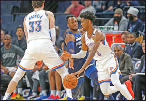 OKLAHOMA CITY Thunder’s Mike Muscala, left, sets a pick for Shai Gilgeous-Alexander, right, of Canada as he drives past Minnesota Timberwolves’ Josh Okogie in the first half of an NBA game Monday in Minneapolis. The Thunder won 117-104. (AP Photo)