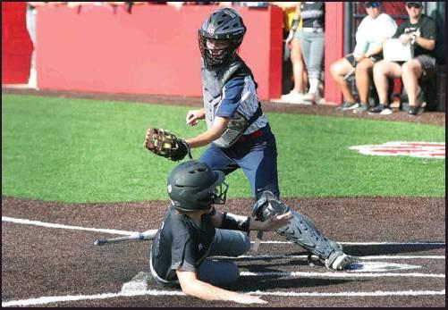 MAKING A play at the plate is Ponca City catcher Camryn Suggs during a game Tuesday against Sand Springs. The Ponca City Lady Cats lost an 11-1 decision to Sand Springs in a district game played at the West Middle School softball field. This photo was provided by Larry Williams.