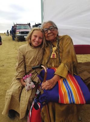 Helena Zengel sits beaming next to her Kiowa teacher. Photo by Lynda DeLaune.