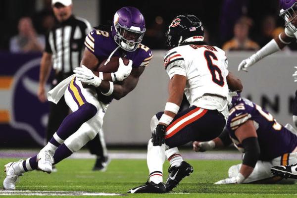 MINNESOTA VIKINGS running back Alexander Mattison (2) rushes for yards in the third quarter of a NFL game between the Minnesota Vikings and the Chicago Bears at U.S. Bank Stadium in Minneapolis.