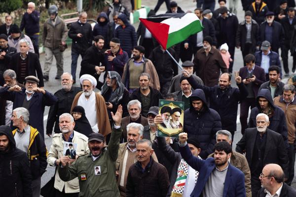 IRANIANS CARRY a Palestinian flag as they demonstrate in support of Yemen and Palestinians, following the Friday noon prayers in Tehran on Jan. 12, 2024. Iran on Jan. 12 lambasted strikes in Yemen by US and British forces, saying that the attacks against Tehran-backed Huthi rebels were “arbitrary” and a “violation” of international law. (-/AFP via Getty Images/TNS)
