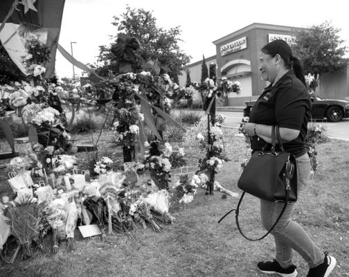 YVI BEATRIZ Leon, who was shopping at the time of the shooting, cries while at the memorial outside the mall honoring the victims of a mass shooting at Allen Premium Outlets in Allen, Texas on Monday, May 8, 2023. A gunman fatally shot eight people and wounded seven others Saturday at the mall before being killed by a police officer. (Juan Figueroa/The Dallas Morning News/TNS)