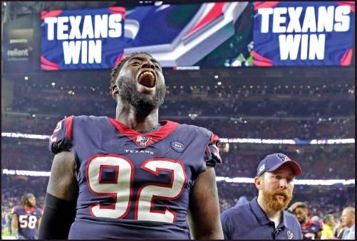 HOUSTON TEXANS nose tackle Brandon Dunn (92) celebrates after an NFL wild-card playoffgame against the Buffalo Bills Saturday in Houston. The Texans won 22-19 and will face the Kansas City Chiefs this week. (AP Photo)