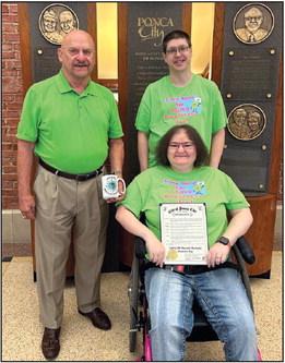 MAYOR HOMER Nicholson (left) presented a proclamation to Patricia “Trish” Hadley (right), declaring Sept. 30 as Limb-Girdle Muscular Dystrophy Awareness Day. Also pictured is Hadley’s husband Justin. The Mayor was coincidentally wearing lime green, the color associated with LGMD Awareness Day. Hadley also have Mayor Nicholson a mug with the LGMD Awareness Day logo. (Photo Provided)