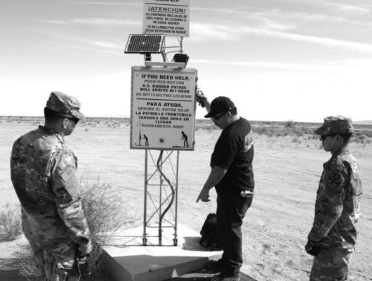 Sgt. Joaquin Torres and Private First Class Alexis Camarillo help Telecommunication Spc. Jose Marquez change rescue beacon lights near the U.S. Border Patrol Wellton Station in Wellton, Arizona, in June 2018. (U.S. Customs and Border Protection/U.S. Border Patrol/TNS)