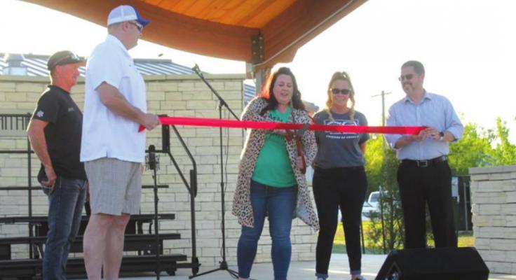 Traditional ribbon cutting at the Kay County Amphitheater Opening Ceremony. Left to right: Richard Hinthorn, Newkirk Main Street Board Member; Scott Kempenich, Newkirk Main Street board member, Holly Cline, Newkirk Main Street Board President (cutting ribbon), Alyssa McCleery, Newkirk Main Street Director, Ryan Smykil, Newkirk Main Street board member and city manager. Photo by Darlene Fields