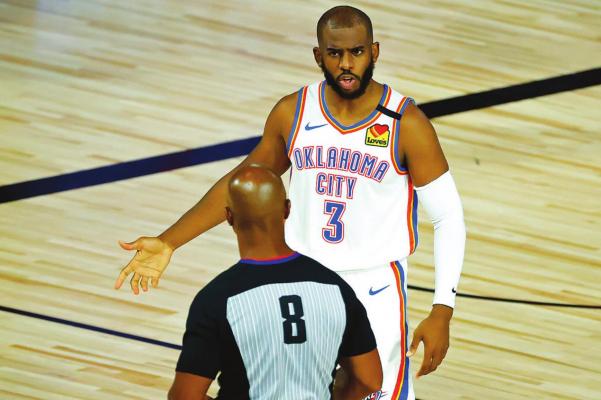 OKLAHOMA CITY Thunder’s Chris Paul (3) discusses a call with referee Marc Davis (8) during the first half of an NBA basketball game against the Oklahoma City Thunder’ Wednesday, Aug. 5, 2020, in Lake Buena Vista, Fla. (Kevin C. Cox/Pool Photo via AP)
